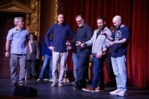 Adults performing at the close of a comedy improv class