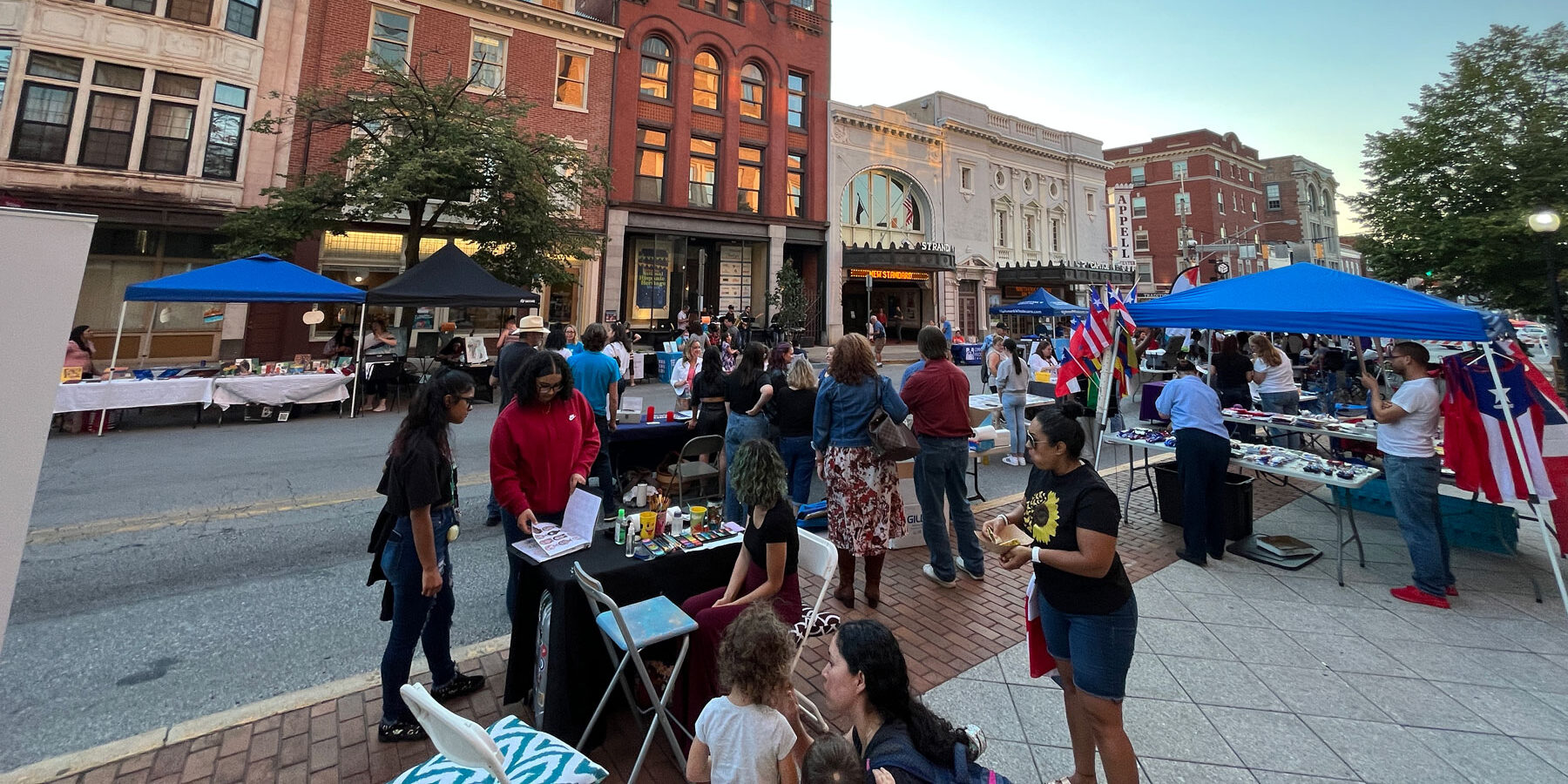 Photo of community gathering for a street fair in front of the Appell Center