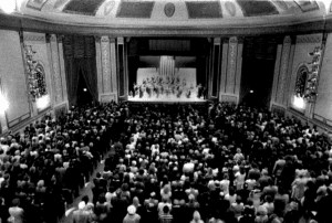 blackk and white photo of a filled Strand Theatre at the 1980 Reopening Gala with Ella Fitzgerald performing