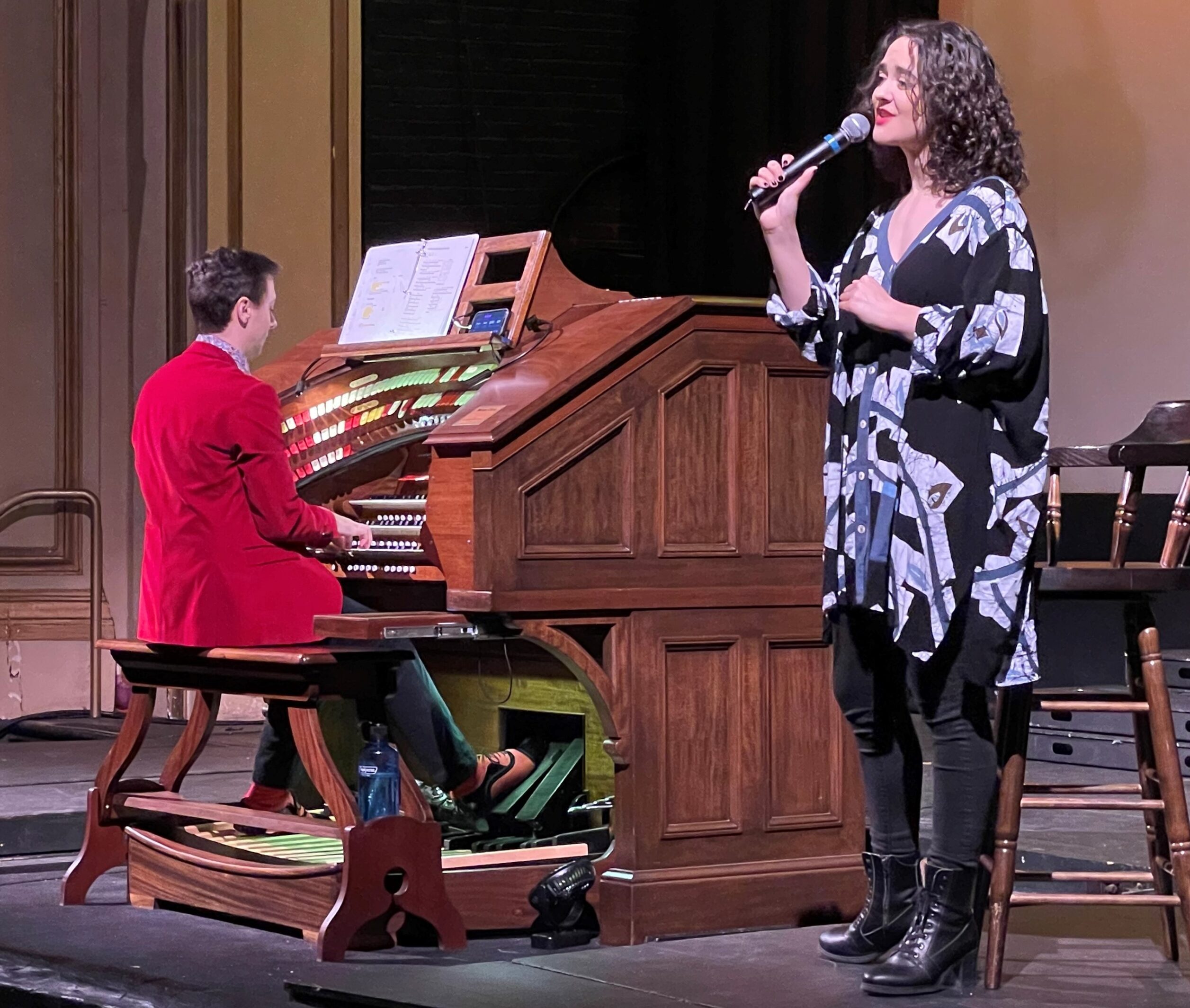 picture of Nathan Avakian playing the organ while Claire Avakian sings