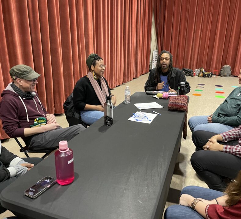 A group of people meeting around a table
