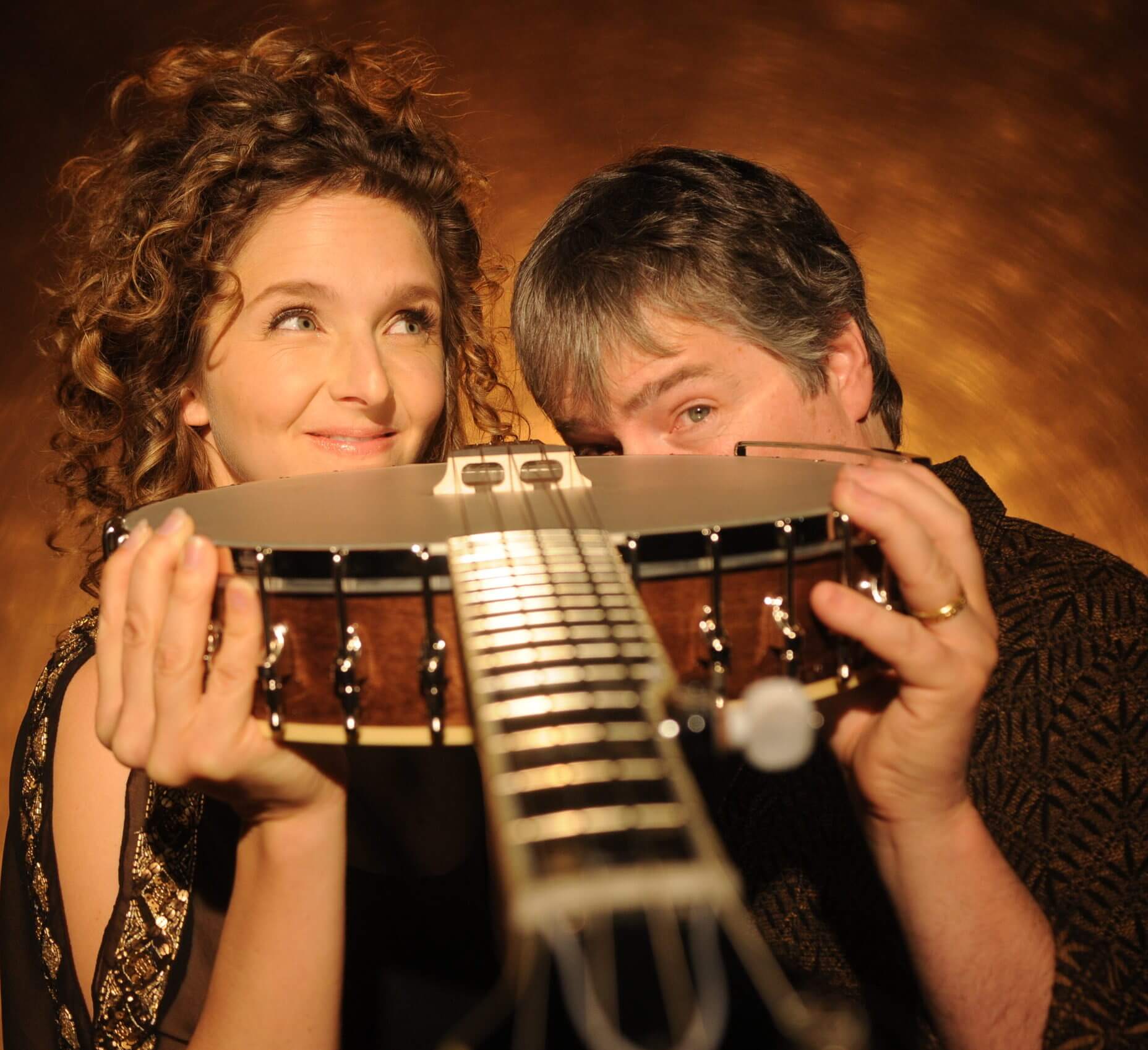 BELA FLECK & ABIGAIL WASHBURN olding a banjo to the camera