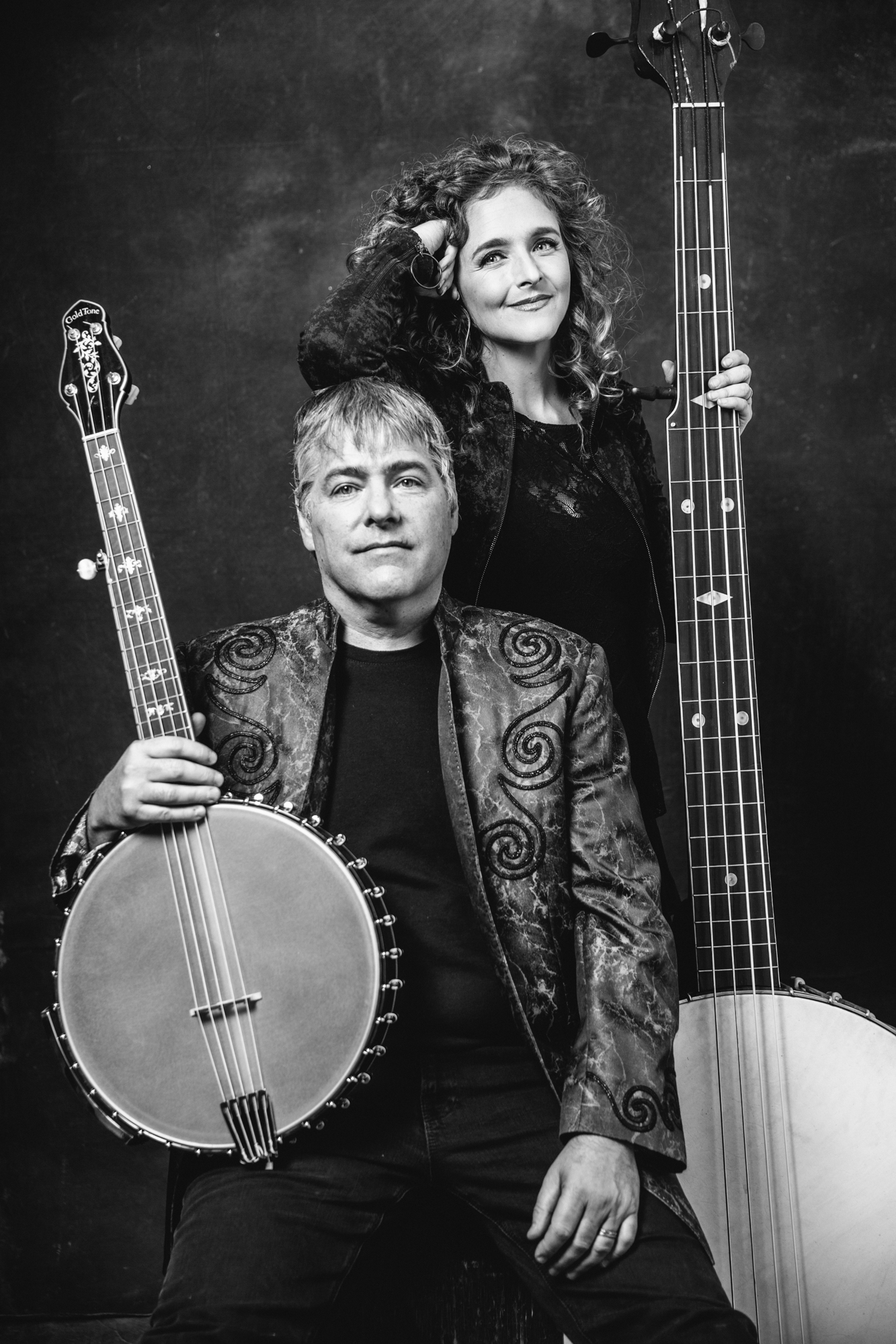 Bela Fleck and Abigail Washburn each holding large banjos