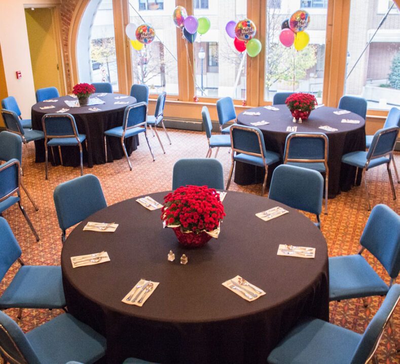 The Appell Center's Donor Lounge set up with round tables and chairs for a party.