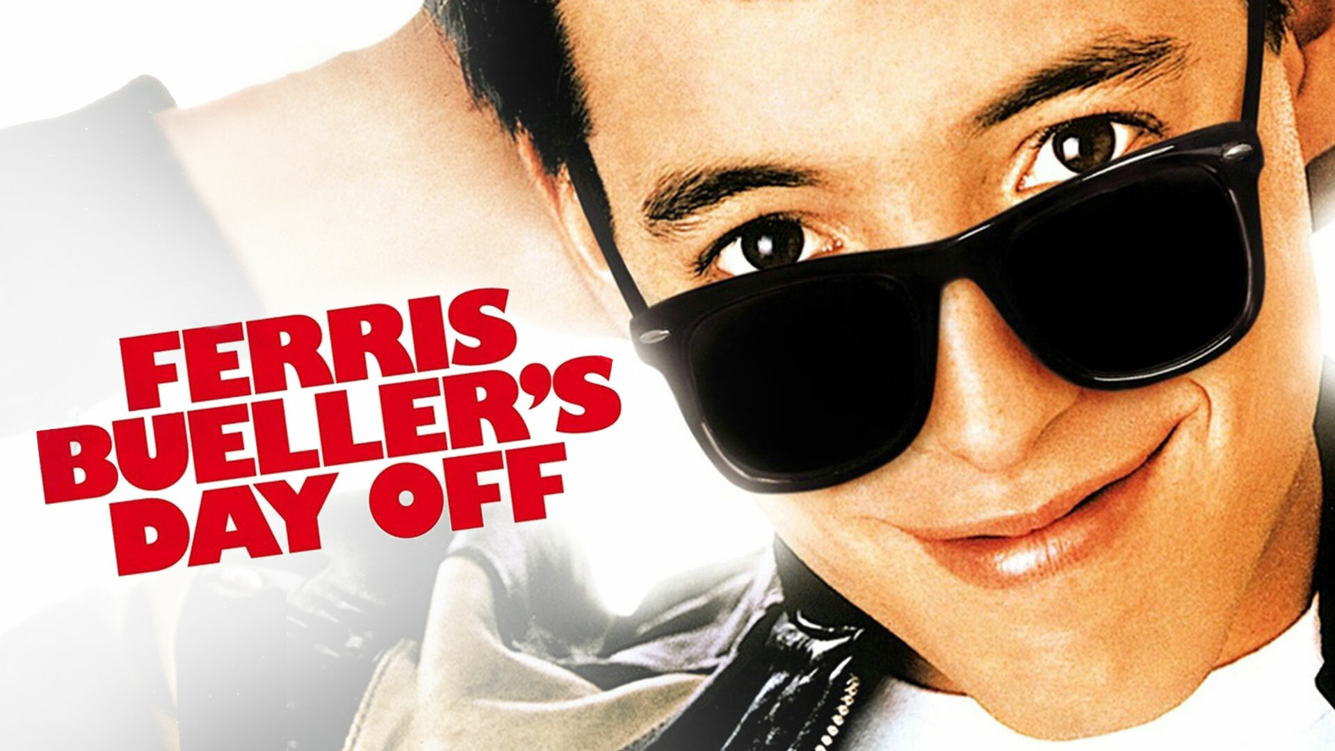 Movie Title Image for Ferris Bueller's Day Off, featuring Ferris Bueller smiling at the camera with black sunglasses on the top of his nose and hands behind his head.