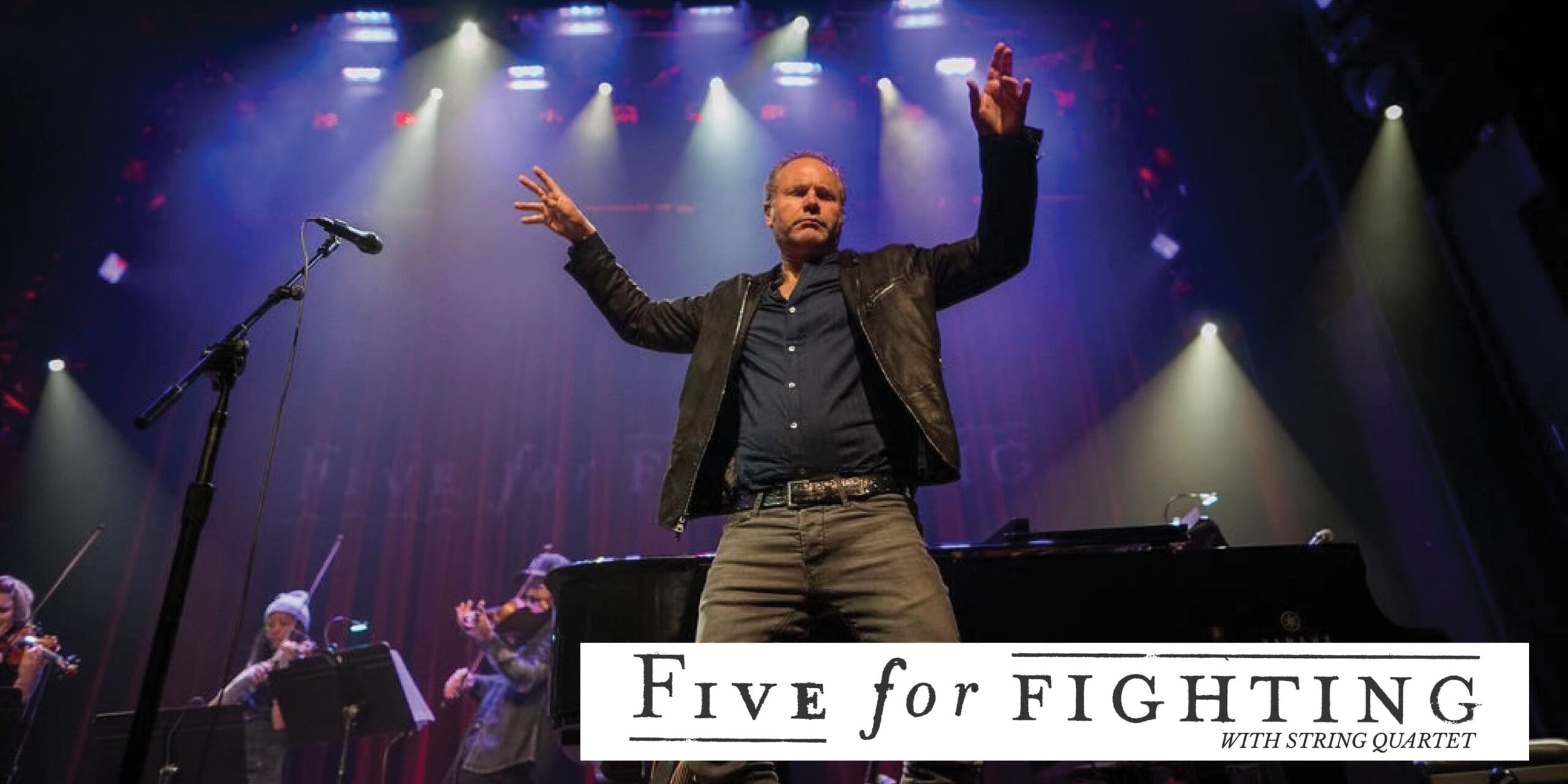 photo of Five For Fighting on stage with band logo at the bottom