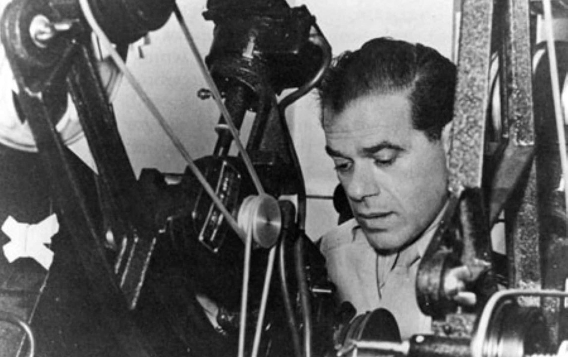 Director Frank Capra sitting behind a camera