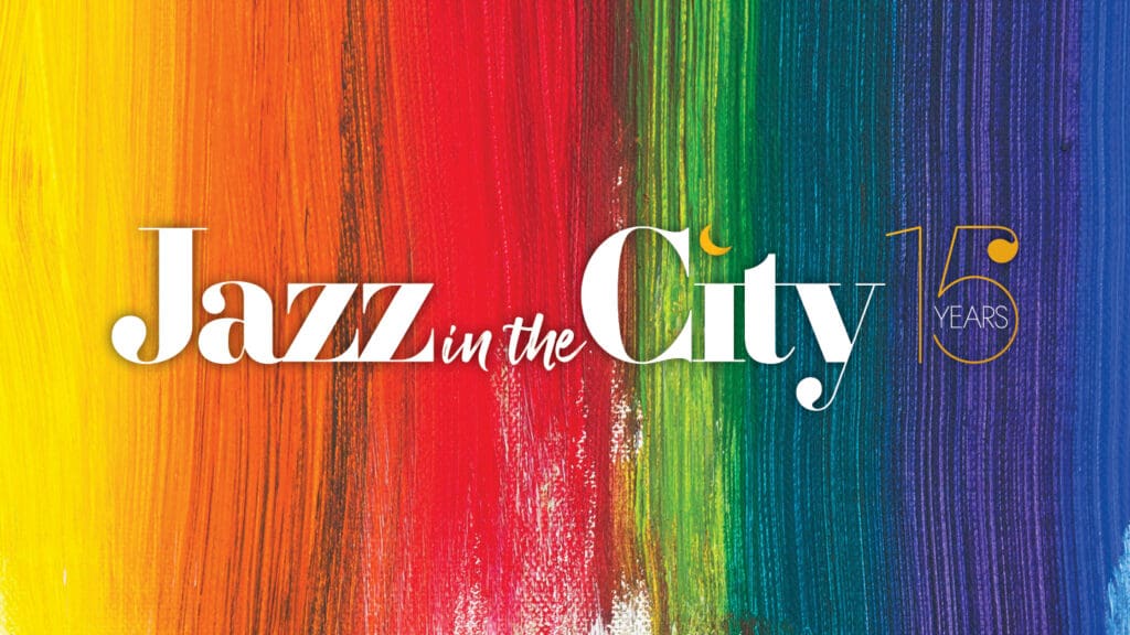 Jazz in the City logo across rainbow stripe background