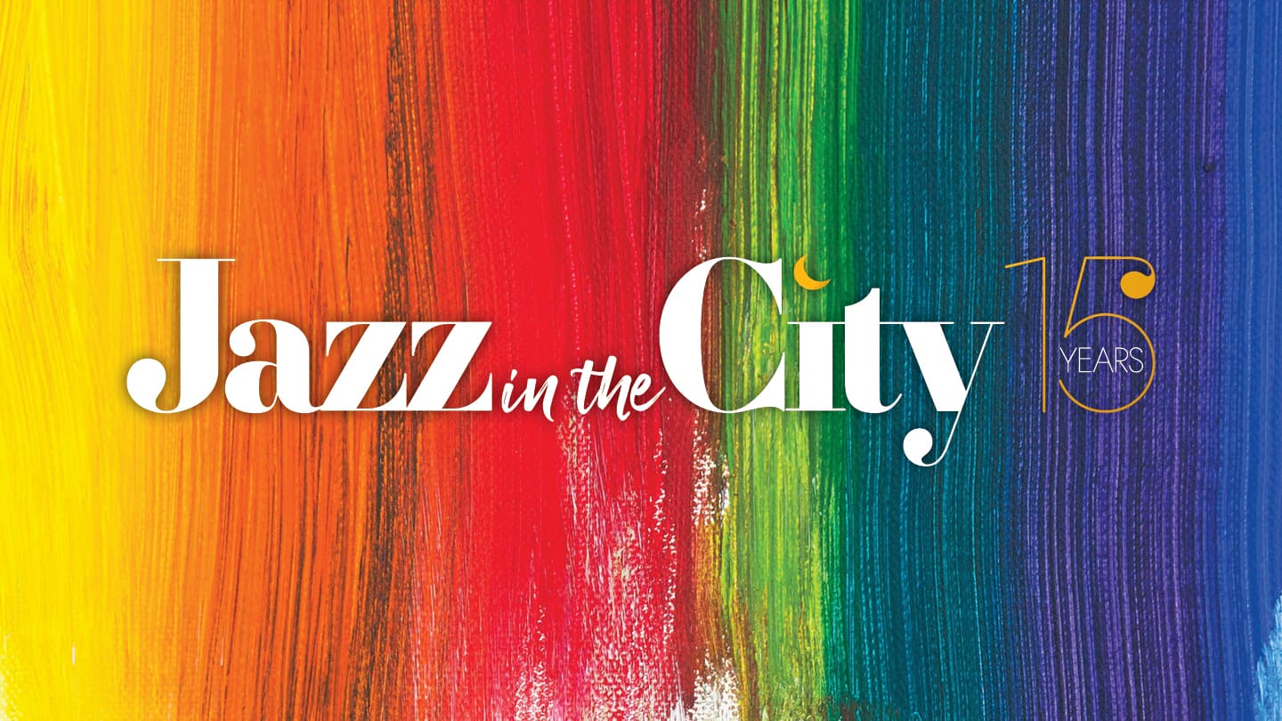 Jazz in the City logo across rainbow stripe background