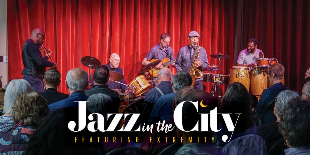 The fusion band EXTREMITY performing in the Studio at the Appell Center in front of a red curtain