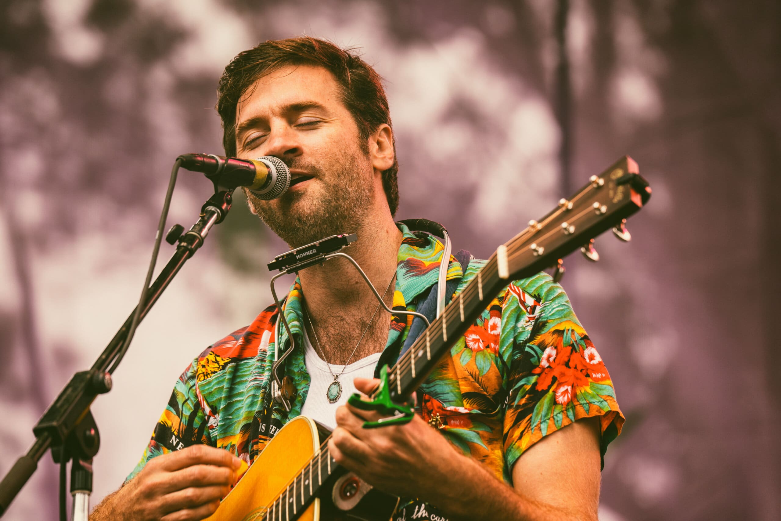 folk singer John Craigies at microphone with acoustic guitar