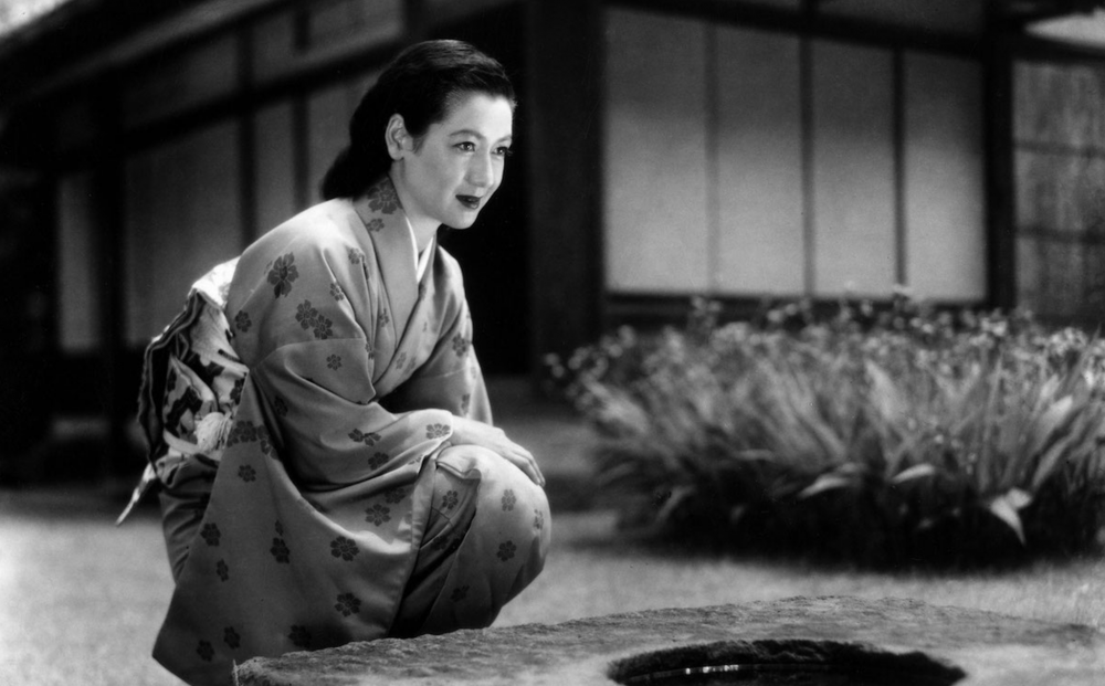 b/w image of asian woman in a kimono kneeling on the floor