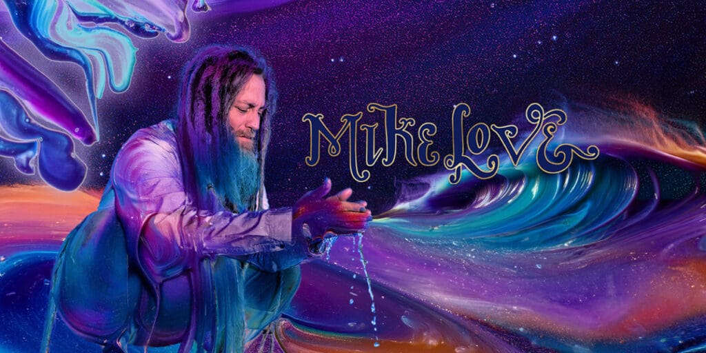 tour photo of Mike Lovecroucing with hands out stretched on colorfull purple background