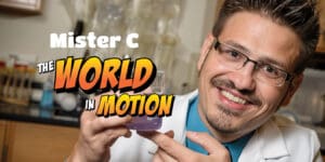 scientist Mister C smiling into camera with his title in comic like font