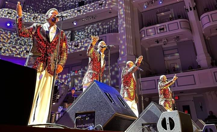 Singers performing on stage in Motown Christmas