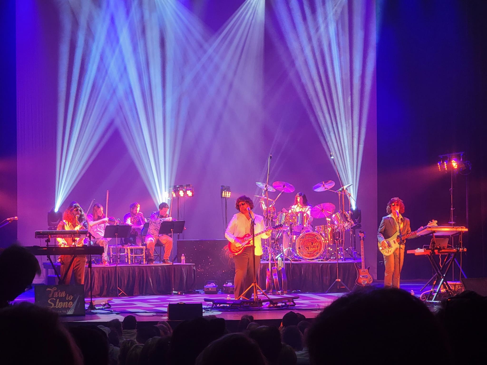 ELO Tribute live on stage with purple lights and haze