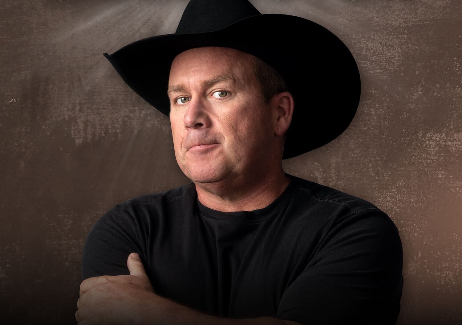 Singer comedian Rodney Carrington in black short and cowboy hat with this name above his head