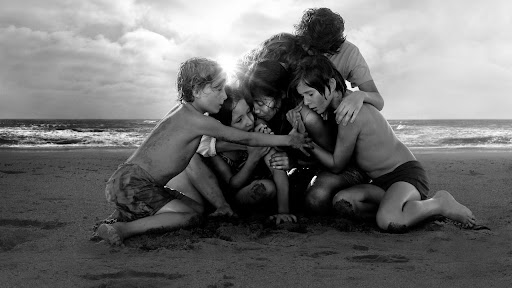 black and white image of children huddled together