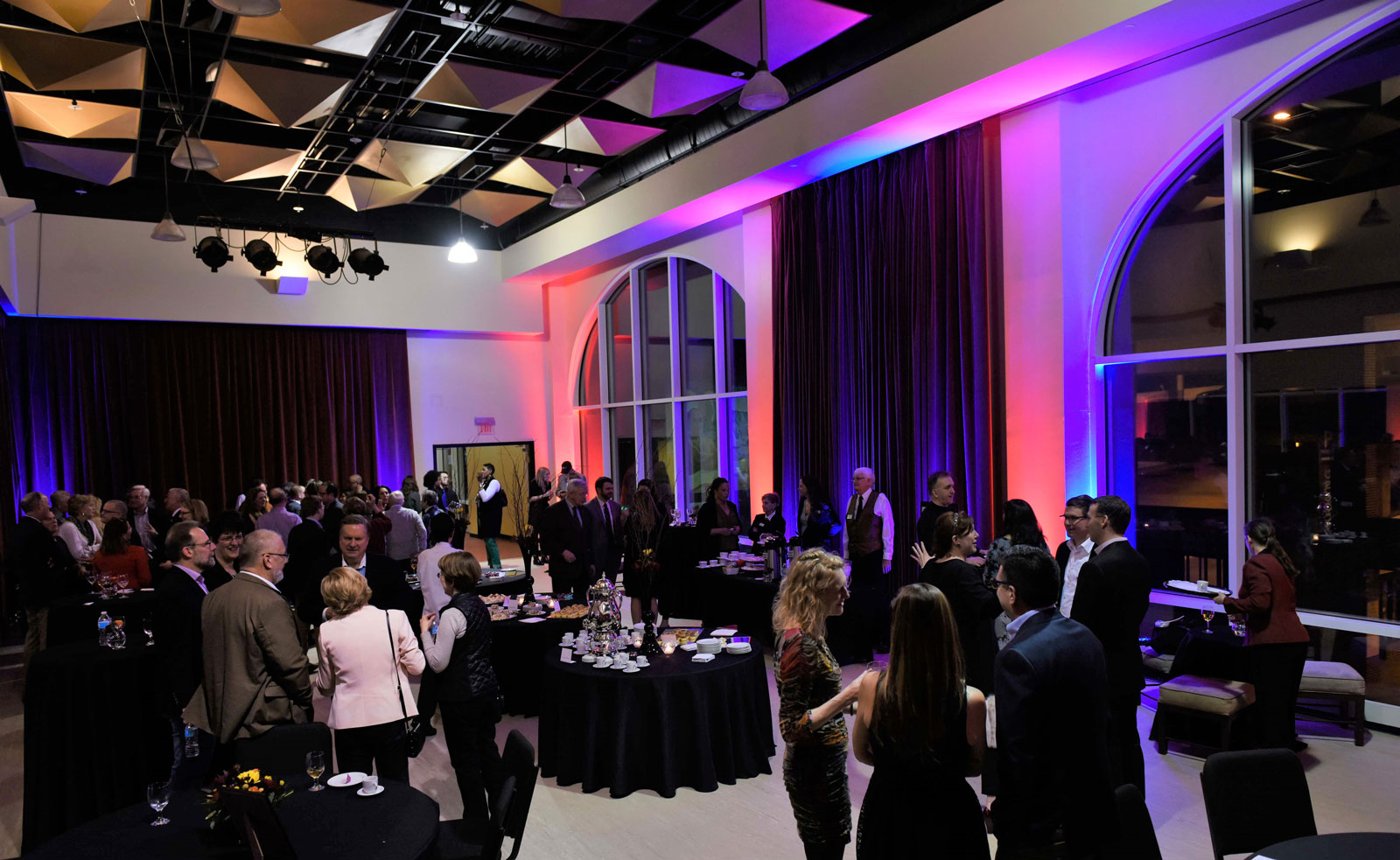 The Studio at the Appell Center during an evening event with guests, food and drink stations and dramatic lighting.