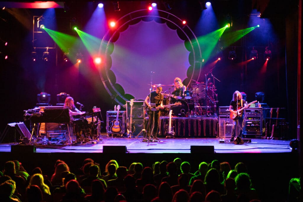 The Machine Performs Pink Floyd live on stage with colorful lights