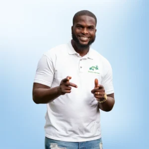 photo of Tavon Parker in a white short-sleeve shirt pointing to viewer with a big smile