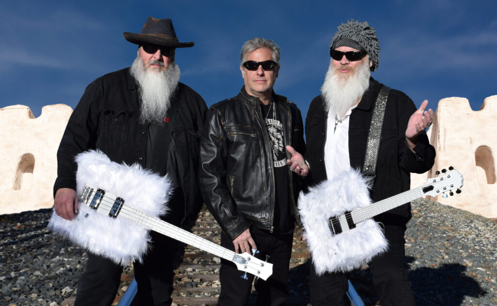 3 members of Thunderbeard posing with furry guitars