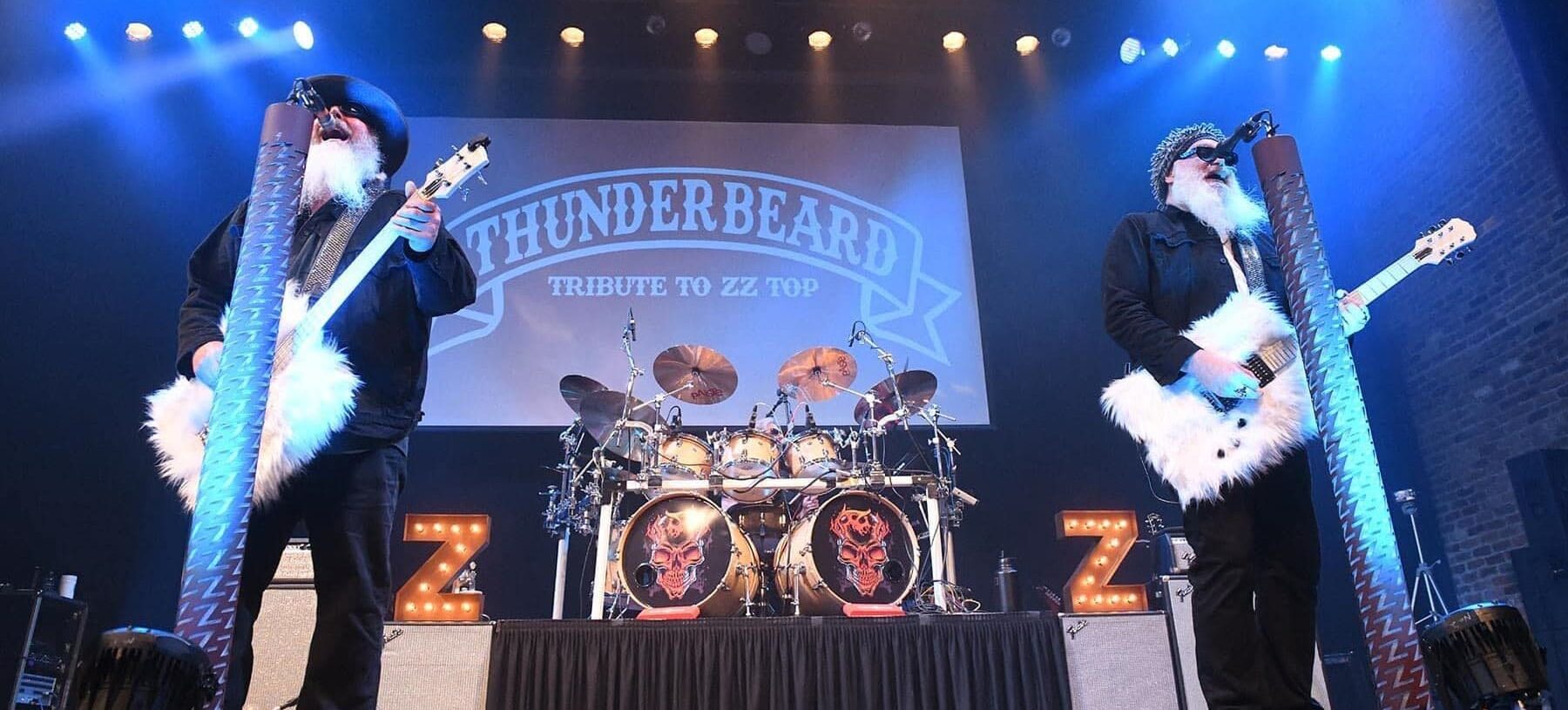 3 members of Thunderbeard performing on stage