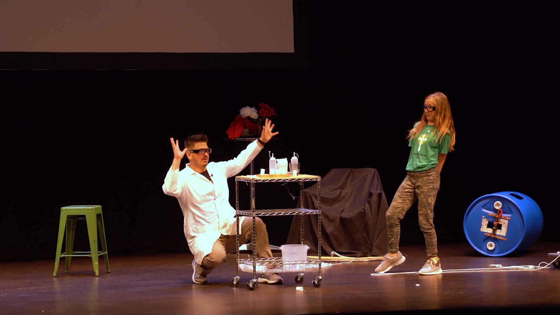 Scientist Mister C and a young member of the audience perdoem an experiment on stage