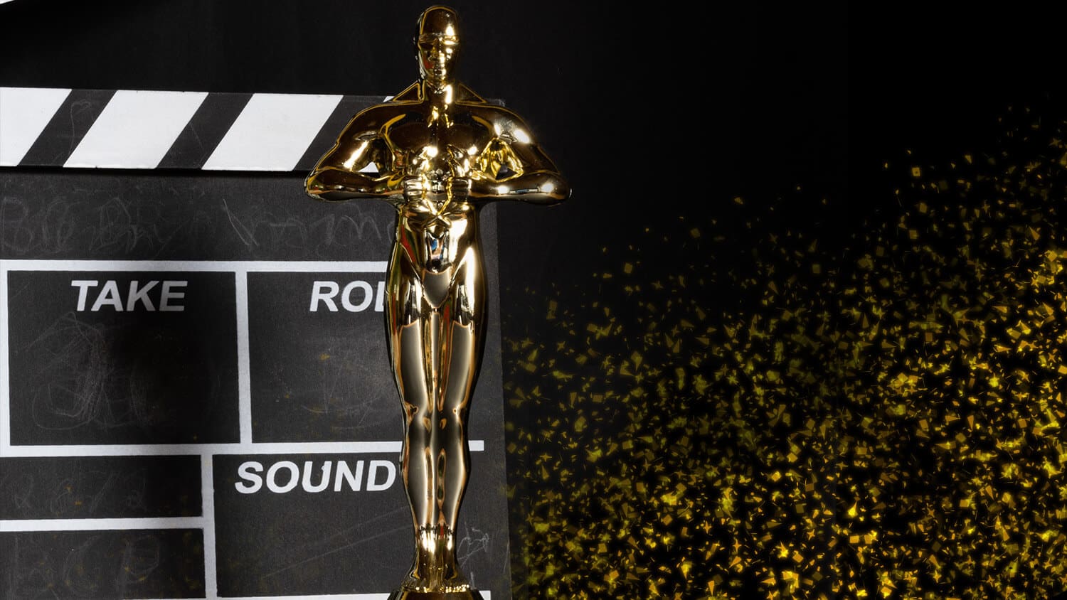 photo of Oscar Award Statue in front of director's clap board