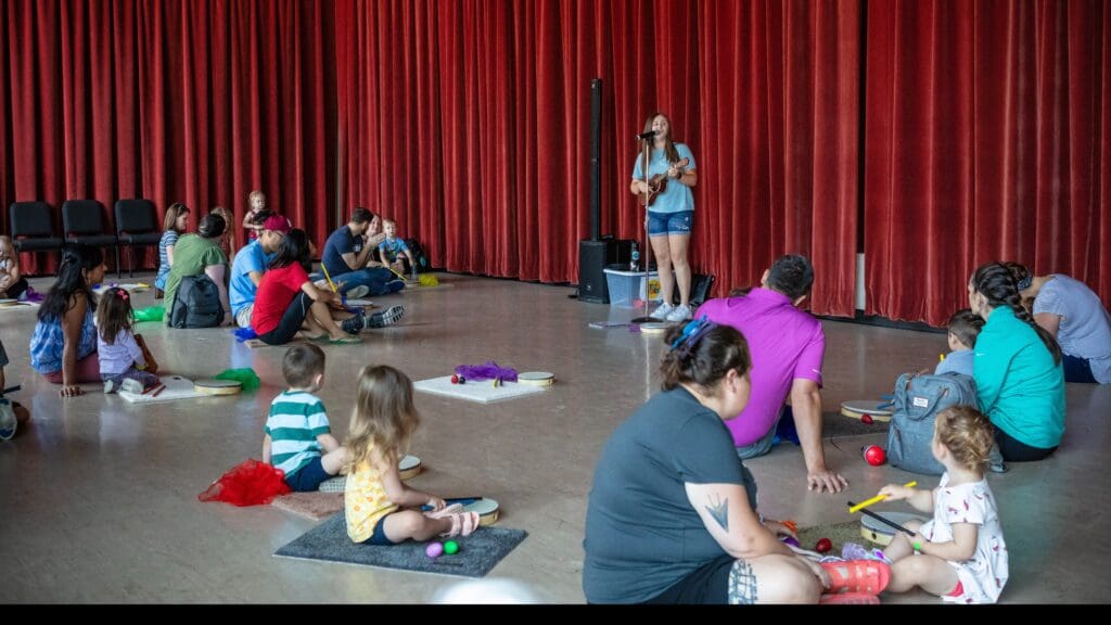 A group of families participating in a music class