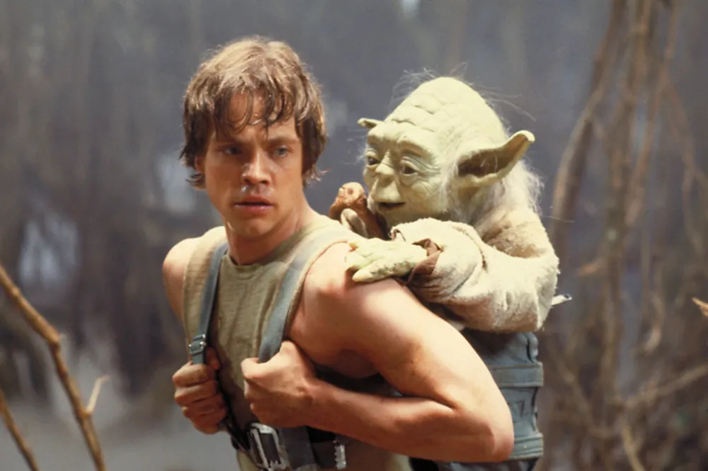 Luke Skywalker in Jedit training with Yoda on his back