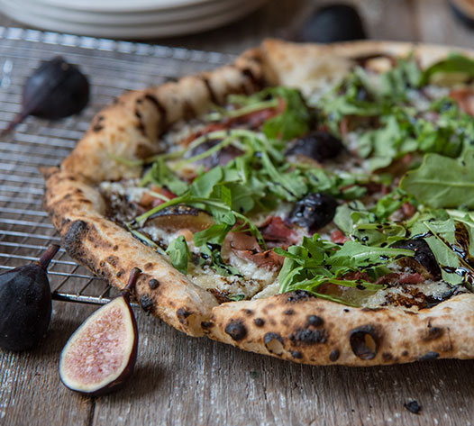 A wood fired pizza from restaurant Fig & Barrel