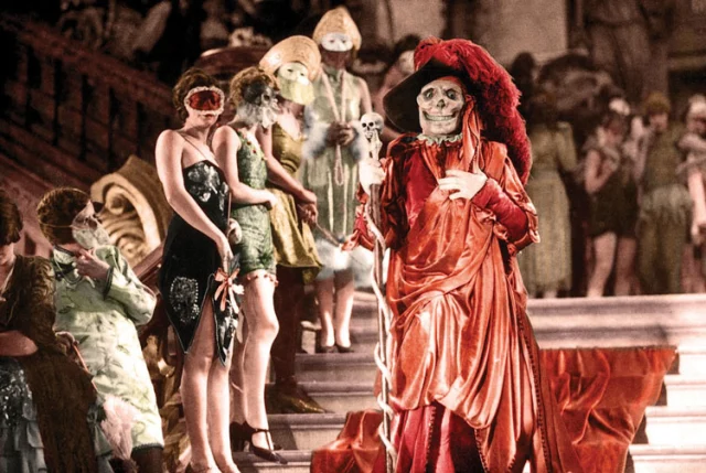 Scene from The Phantom of the Opera whe Erik (the Phantom) interrupts the party wearing the scarlet robes of the Red Death.